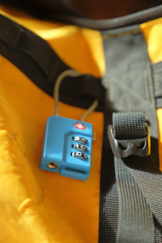 Travel Sentry | Should You Receive a Key with a TSA Lock? Blue TSA lock on a yellow bag