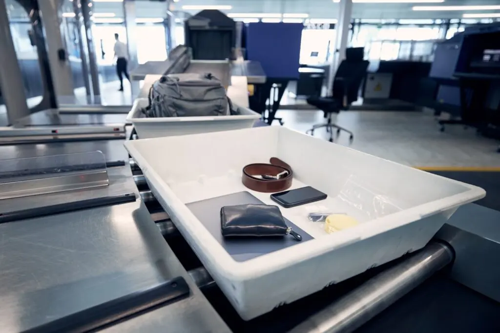 Travel Sentry | What Do You Have to Remove at Airport Security? Personal items in security trays at an airport checkpoint